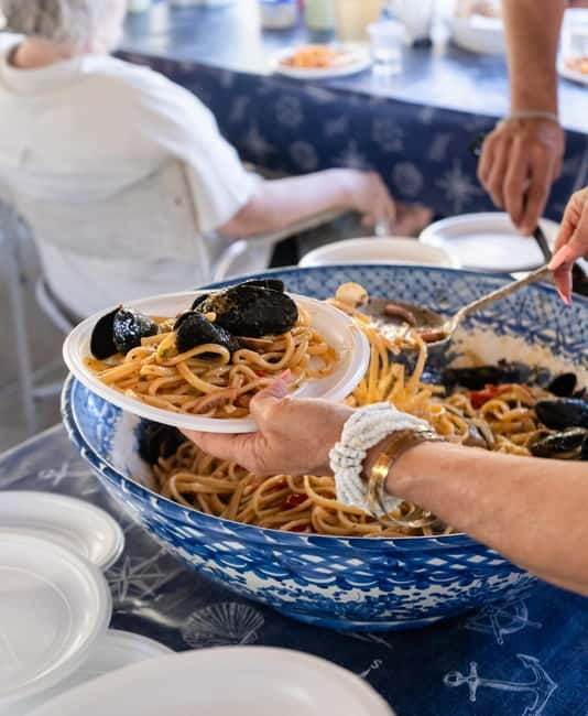 Ischia: Boat tour with swimming stops and lunch on board - Varulo (Spiaggia delle Monache): dessert, fruit, and quieter water