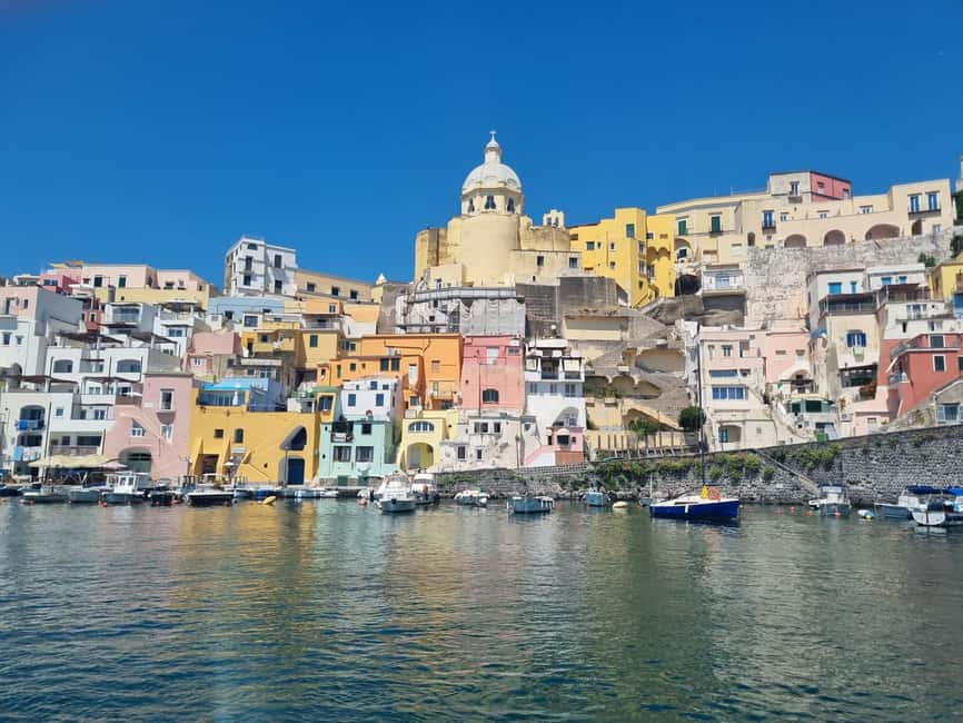 Procida: Sea View Private Boat Tour with Snorkeling - Meeting at Corricella: that big umbrella with the table and flag